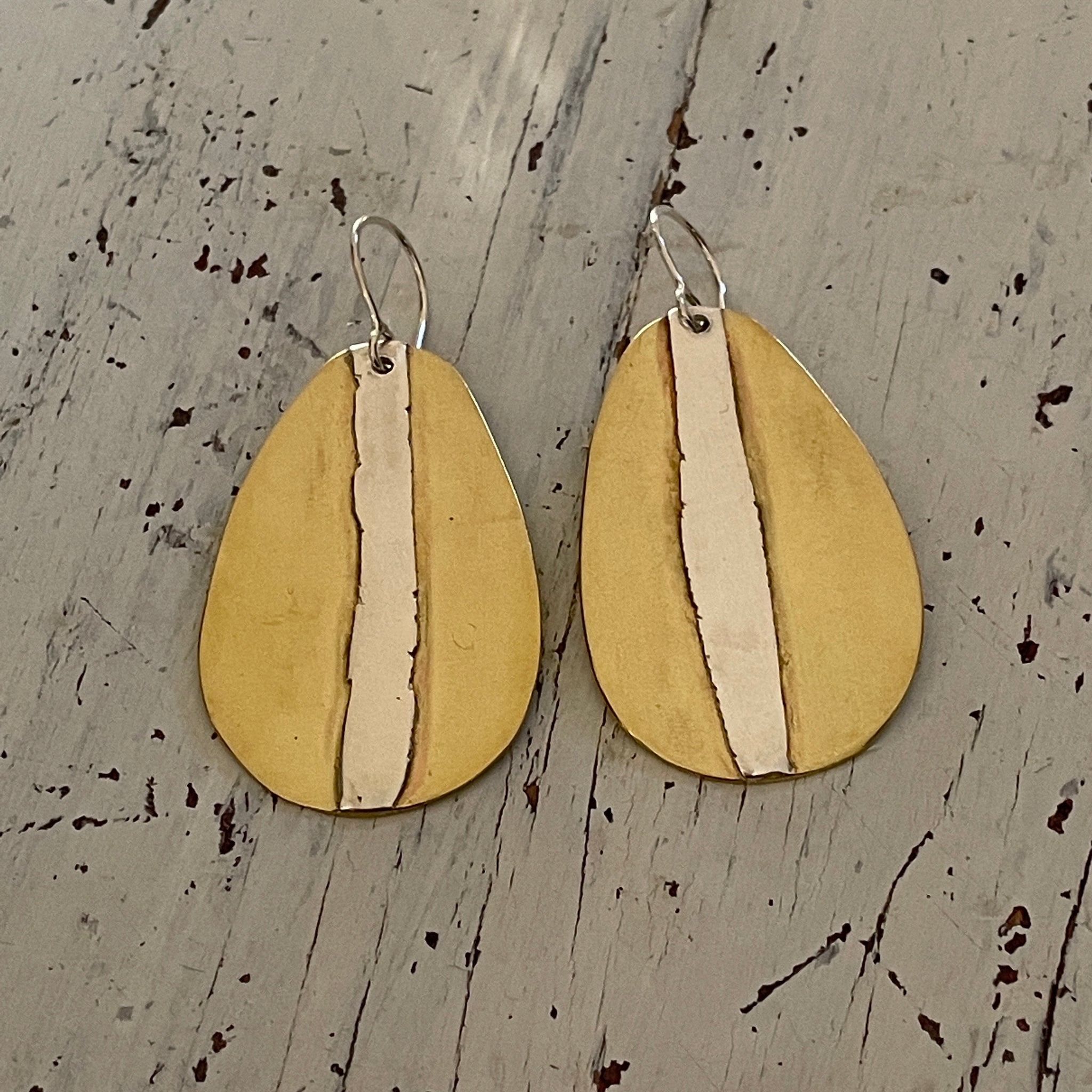 Tear shape brass earrings with silver appliqué